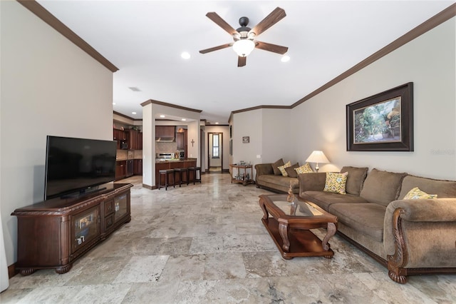 living room with ceiling fan and crown molding