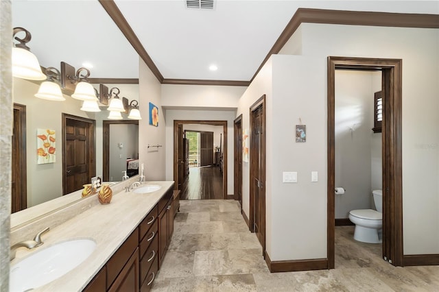 bathroom featuring vanity, toilet, and crown molding