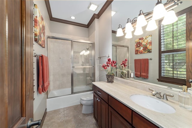 full bathroom featuring tile patterned floors, crown molding, toilet, shower / bath combination with glass door, and vanity