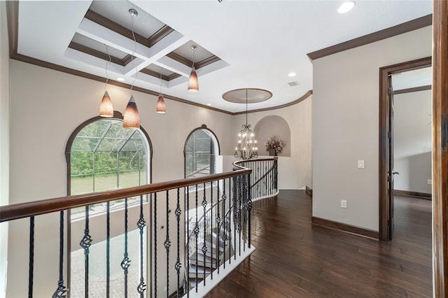 hallway with a chandelier, crown molding, dark hardwood / wood-style floors, and coffered ceiling