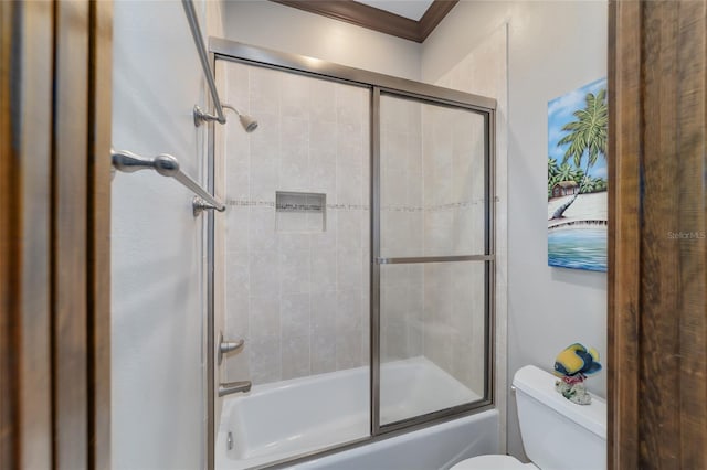 bathroom featuring shower / bath combination with glass door, ornamental molding, and toilet