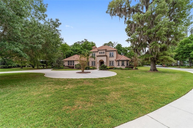 mediterranean / spanish-style house with a front yard