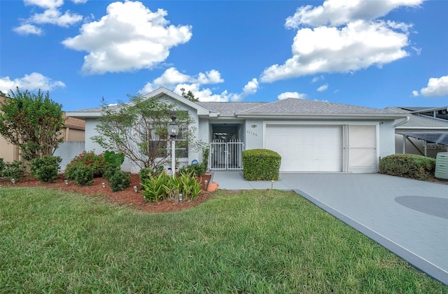 single story home with a front yard and a garage