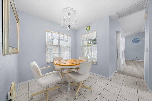 dining space featuring a chandelier and light wood-type flooring