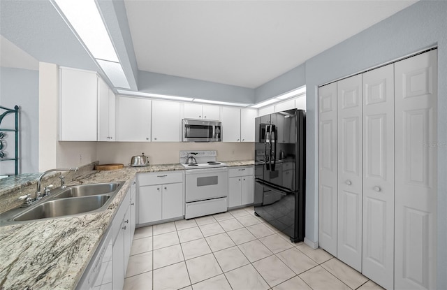 kitchen with white range with electric cooktop, white cabinets, black refrigerator, sink, and light tile patterned floors