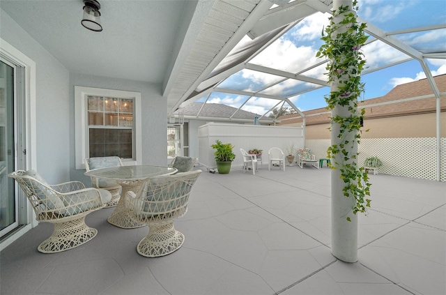 view of patio / terrace featuring glass enclosure