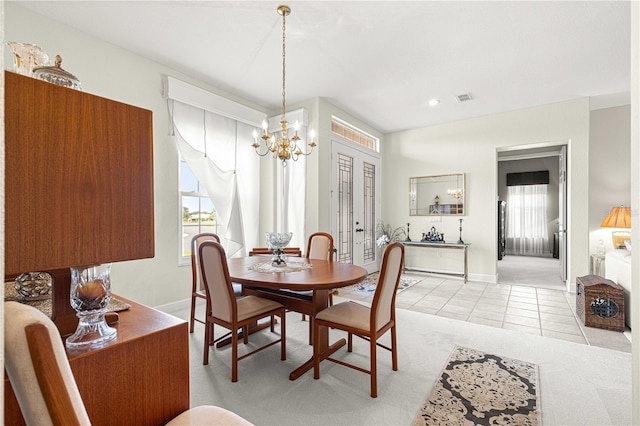 tiled dining room with a chandelier