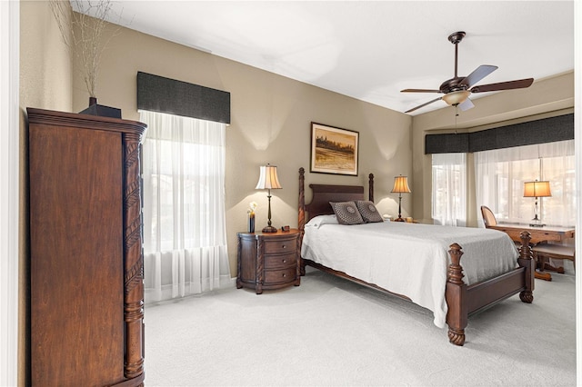 bedroom featuring ceiling fan, carpet flooring, and lofted ceiling