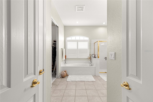 bathroom with tile patterned flooring and separate shower and tub