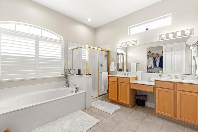 bathroom with shower with separate bathtub, tile patterned floors, and vanity