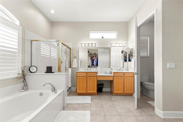 full bathroom featuring independent shower and bath, tile patterned flooring, vanity, and toilet