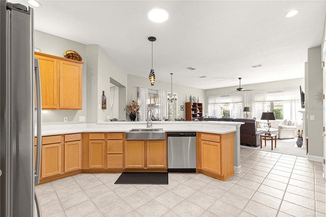 kitchen featuring kitchen peninsula, hanging light fixtures, sink, ceiling fan, and appliances with stainless steel finishes