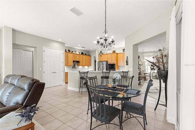 tiled dining room featuring a notable chandelier