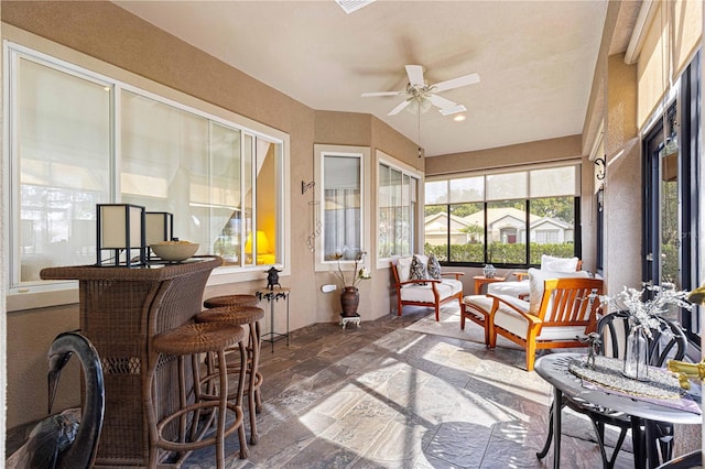 sunroom featuring a wealth of natural light and ceiling fan