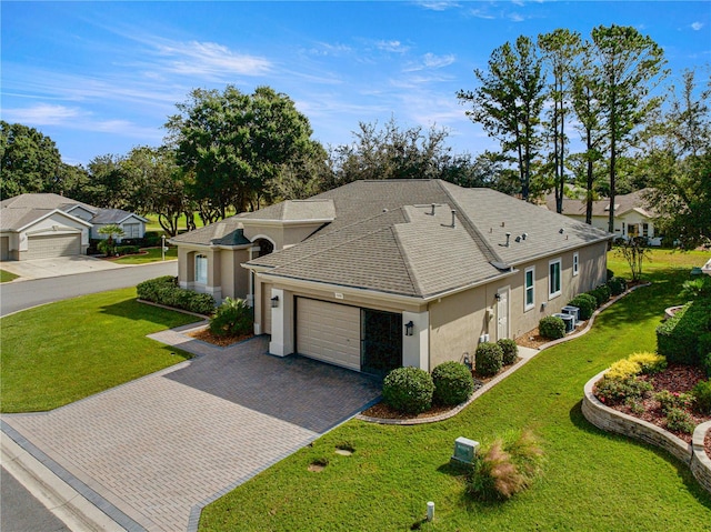 view of front of property with a garage and a front yard