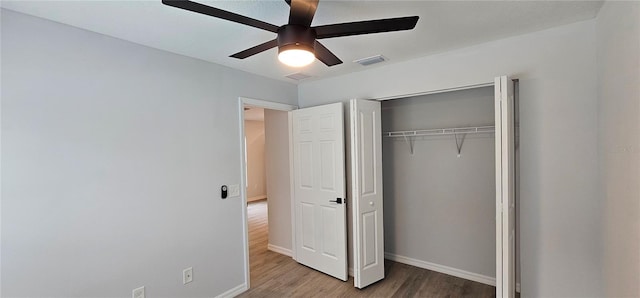 unfurnished bedroom with a closet, hardwood / wood-style floors, and ceiling fan