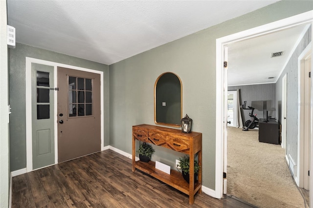 foyer entrance featuring hardwood / wood-style floors and a textured ceiling