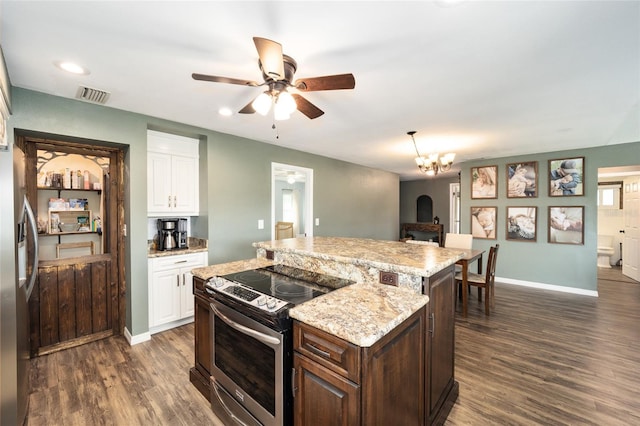 kitchen featuring stainless steel appliances, dark brown cabinetry, a center island, white cabinets, and dark wood-type flooring