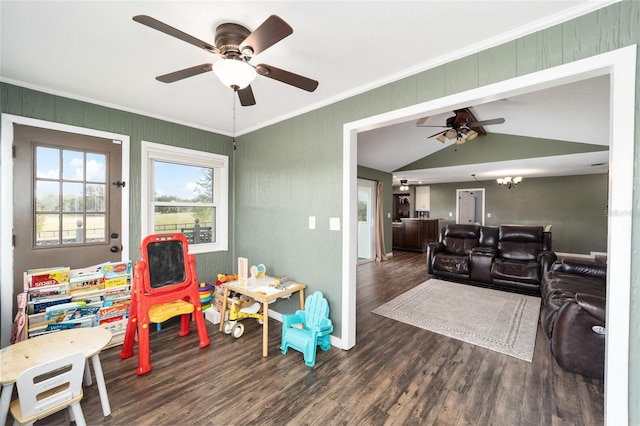 recreation room featuring dark wood-type flooring, ceiling fan, vaulted ceiling, and ornamental molding