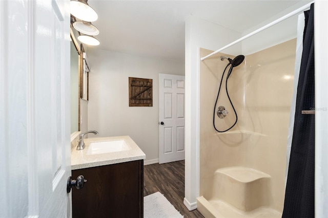 bathroom featuring a shower with shower curtain, hardwood / wood-style flooring, and vanity