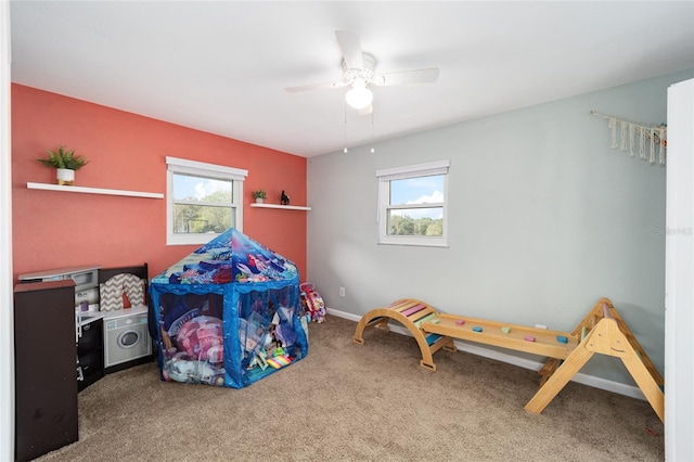 carpeted bedroom featuring ceiling fan and multiple windows