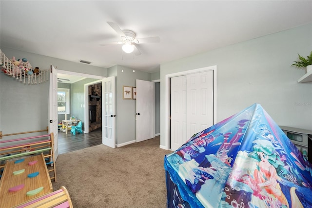 carpeted bedroom featuring a closet and ceiling fan