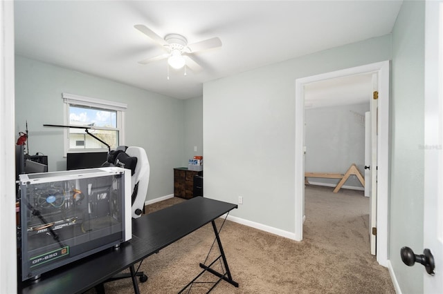 carpeted office space featuring ceiling fan