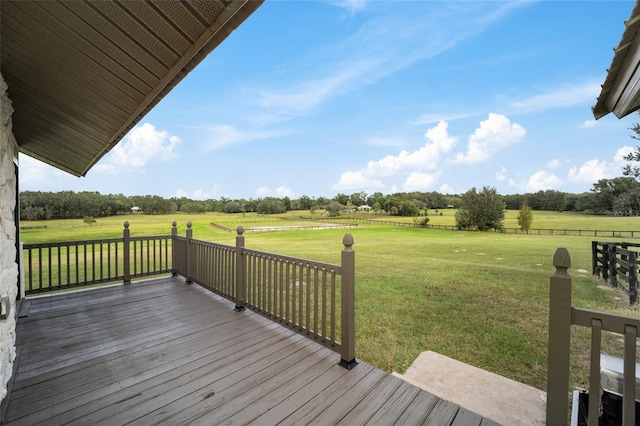 deck featuring a lawn and a rural view