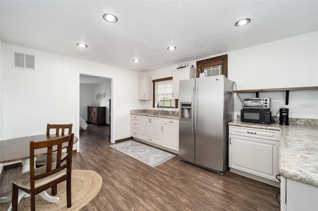 kitchen with dark hardwood / wood-style floors, sink, stainless steel fridge, and white cabinets