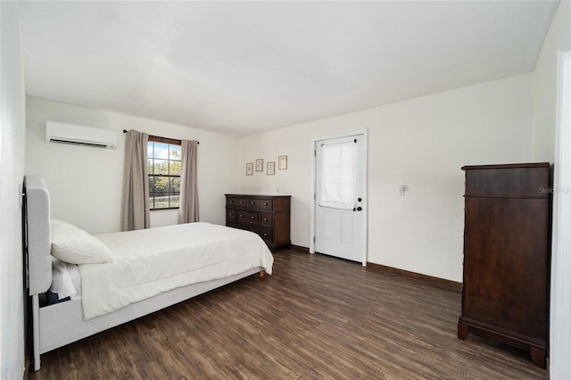 bedroom featuring dark hardwood / wood-style flooring and a wall mounted air conditioner