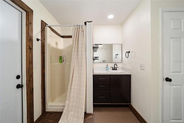 bathroom featuring a shower with shower curtain, vanity, and hardwood / wood-style floors