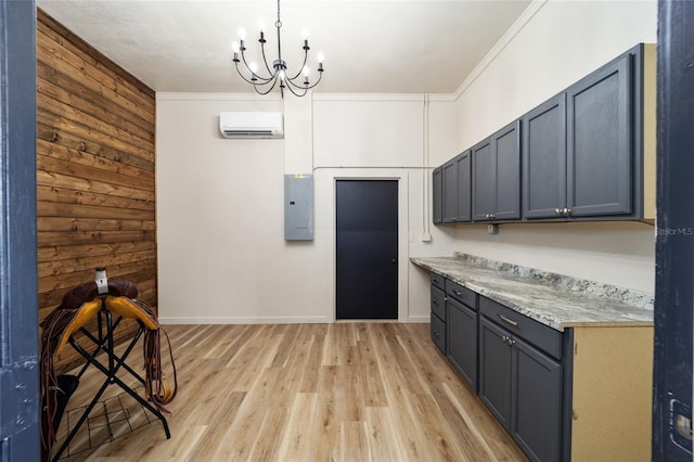 kitchen featuring electric panel, wooden walls, ornamental molding, light wood-type flooring, and a wall mounted air conditioner