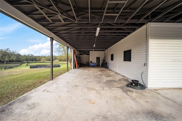 view of parking / parking lot with a yard and a carport