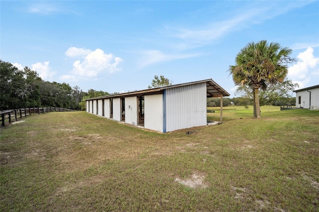 view of outbuilding featuring a yard