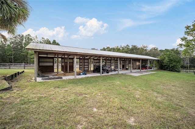 rear view of property featuring an outdoor structure