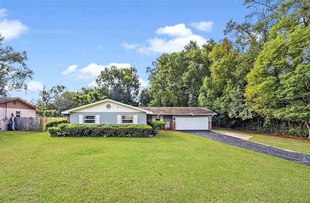 ranch-style home with a garage and a front lawn