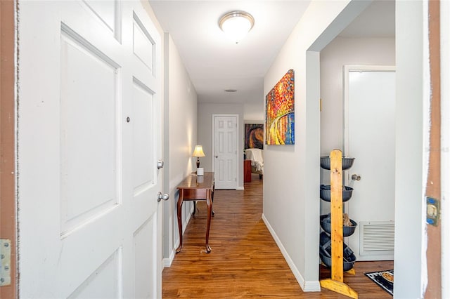 hallway with wood-type flooring