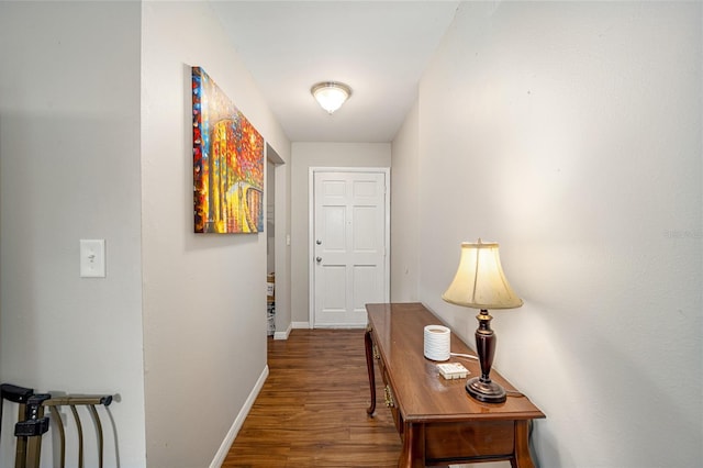 corridor with dark hardwood / wood-style flooring