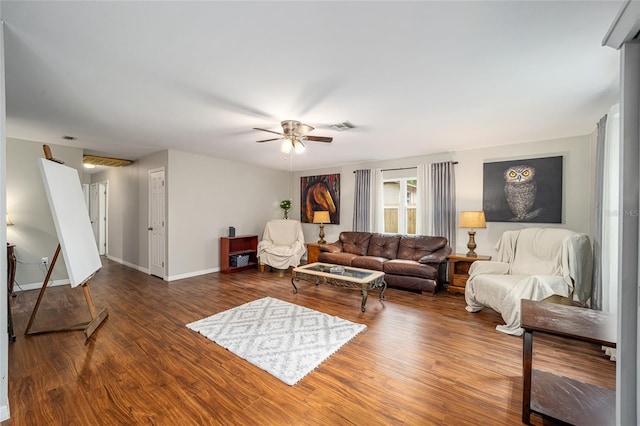 living room featuring ceiling fan and dark wood-type flooring