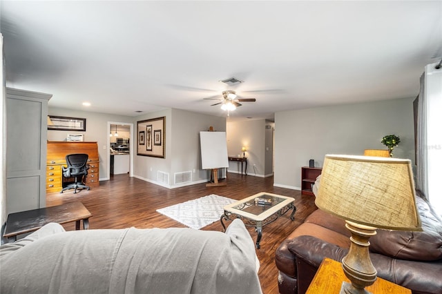 living room featuring ceiling fan and dark hardwood / wood-style flooring