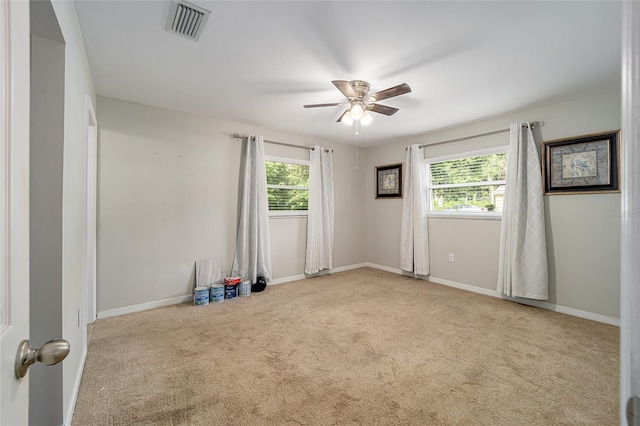 unfurnished room with ceiling fan and light colored carpet