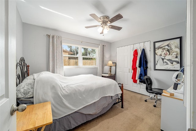 carpeted bedroom featuring a closet and ceiling fan