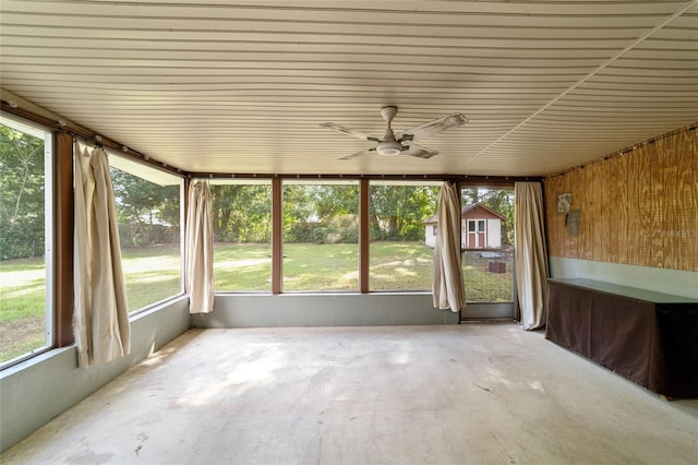 unfurnished sunroom with ceiling fan