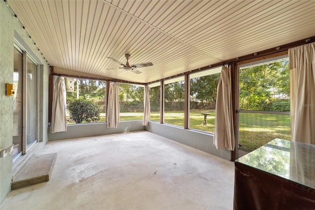 unfurnished sunroom featuring ceiling fan