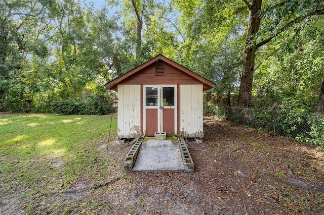 view of outdoor structure featuring a lawn