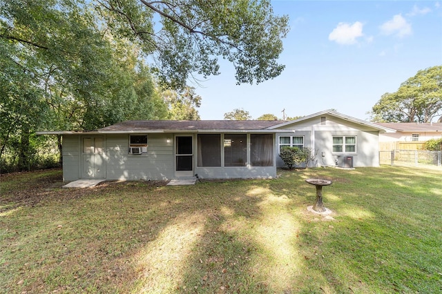 back of property featuring a yard, a sunroom, and central AC unit