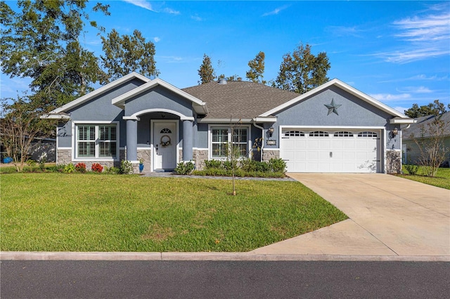 view of front of home featuring a front lawn and a garage