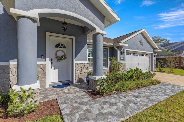 doorway to property with a garage