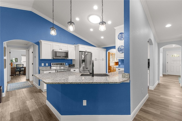 kitchen featuring ornamental molding, white cabinetry, appliances with stainless steel finishes, sink, and light hardwood / wood-style flooring