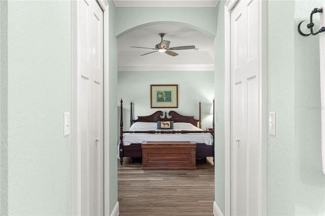 bedroom featuring light hardwood / wood-style floors, ceiling fan, and ornamental molding